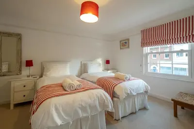 a bedroom with two beds and a window at The Pink House, Aldeburgh in Aldeburgh