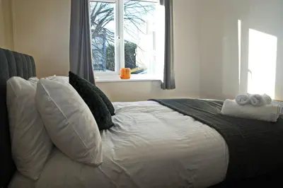 a bedroom with a white bed with pillows and a window at Host & Stay - Clacton Coastal Hideaway in Clacton-on-Sea
