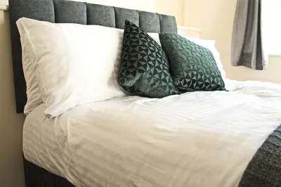 a bed with white sheets and pillows on it at Host & Stay - Clacton Coastal Hideaway in Clacton-on-Sea