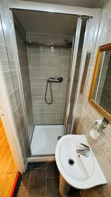 a bathroom with a shower and a sink at White House Lodge in Cambridge