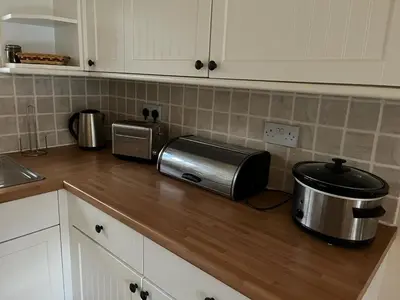 a kitchen counter top with a toaster and a toaster at Two Storey Annex in Cottenham