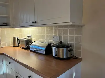 a kitchen counter with a toaster and a slow cooker at Two Storey Annex in Cottenham