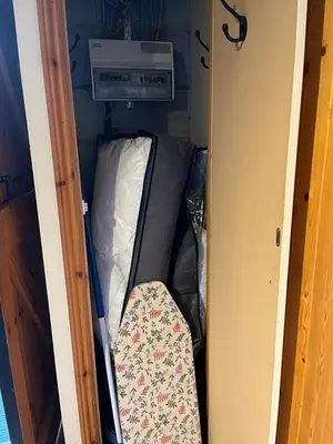 a small room with an open suitcase in a room at Two Storey Annex in Cottenham