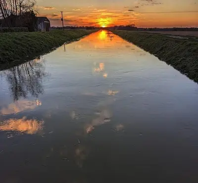 a flooded road with the sunset in the background at Two Storey Annex in Cottenham