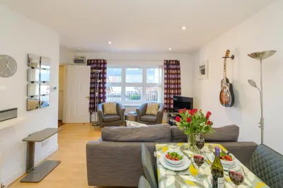 a living room with a couch and a table at Admiral's Rest in Aldeburgh