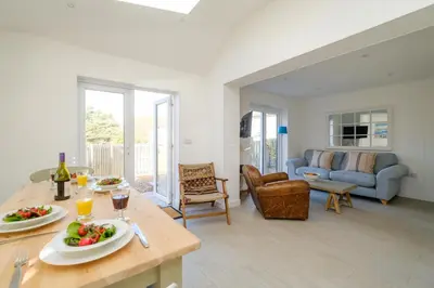 a living room with a table with food on it at The Garden Flat in Aldeburgh