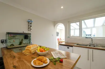 a kitchen with a table with bread and a fish tank at 61 Fairfield Road in Aldeburgh