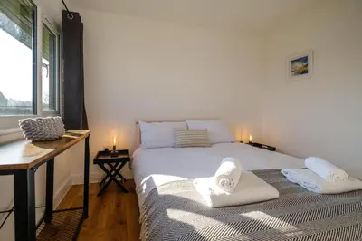 a bedroom with a bed with towels on it at Three Tuns - Garden Suite 3 in Wickham Market