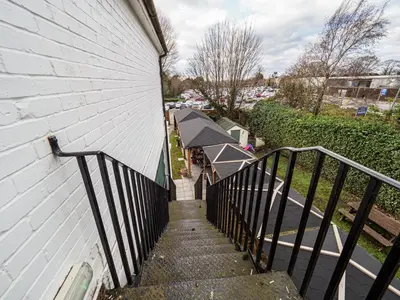 a stairway leading up to a white building at The Live and Let Live in Downham Market