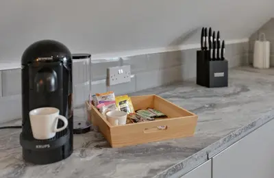 a wooden crate sitting on top of a counter with cups at Towerview Apartments Braintree in Braintree