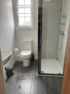 a bathroom with a shower and a toilet and a sink at Towerview Apartments Braintree in Braintree