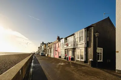 a row of buildings on a street next to the ocean at Pembroke in Aldeburgh