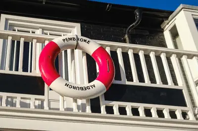 a red and white lifesaver on the side of a house at Pembroke in Aldeburgh