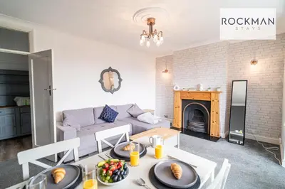a living room with a table with food on it at 5 Bed Apartment Close To Beach with Off-street parking - Perfect for Contractors - Fast Wi-Fi - Close to beach in Southend-on-Sea