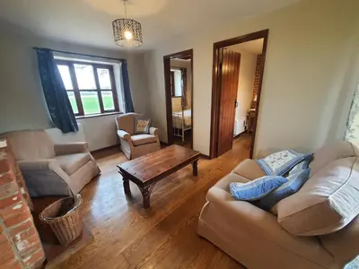 a living room with two couches and a coffee table at Cosy Barn Conversion 3BR (4 pax), Quiet, Close to Pin Mill in Chelmondiston