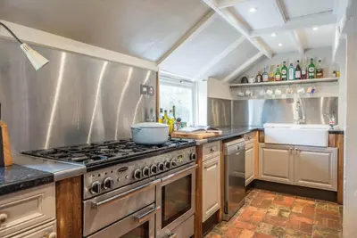 a kitchen with a stove and a sink at Ivy House, Mells in Halesworth