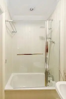 a bathroom with a shower and a tub and a sink at Shearwater Cottage in Aldeburgh