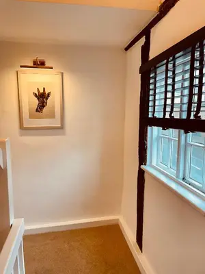 a room with a window and a picture on the wall at Abbey Gardens Cottage in Bury Saint Edmunds