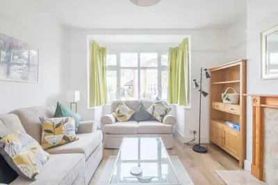 a living room with a couch and a glass table at Charming Central Family Home in Cambridge