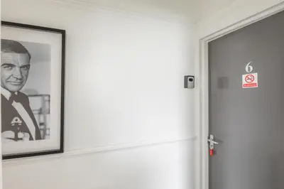 a picture of a man on a wall next to a door at The Modern Cambridge Studio 6 in Cambridge