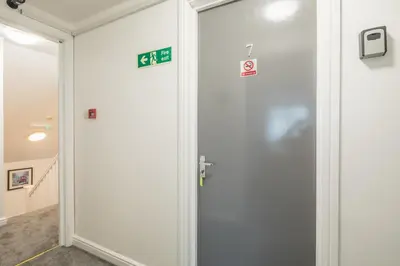 a door in a room with signs on the wall at The Modern Cambridge Studio 7 in Cambridge