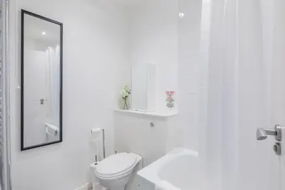 a white bathroom with a toilet and a sink at Lovely 2 bedroom apartment - ideal location in Cambridge