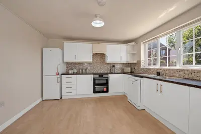 an empty kitchen with white cabinets and appliances at The Grange Luxe2, 5 Bedroom House,Spacious,contractor,family,Internet,free parking,group,study,relocation,easily accessible in Ipswich,Kesgrave in Ipswich