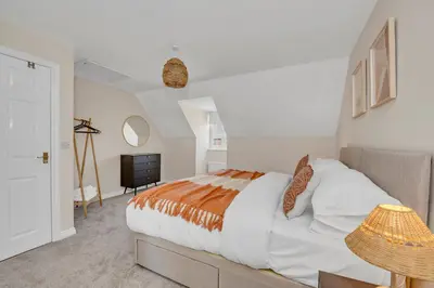 a bedroom with a large bed and a television at The Grange Luxe3, 4 Bedroom House,5-beds,Spacious,contractor,family,Internet,free parking,group,study,relocation,easily accessible in Ipswich,Kesgrave in Ipswich