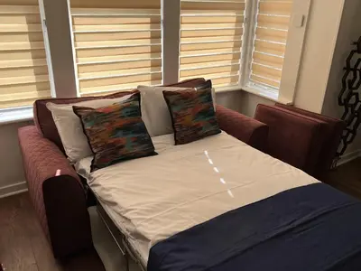 a bed with two pillows on it in a room at Modern accomodation in Westcliff-On-Sea in Westcliff On Sea