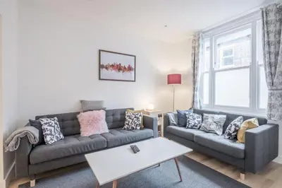 a living room with a couch and a table at Refurbished High Spec CENTRAL Family Home in Cambridge