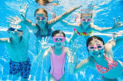 a group of children in a swimming pool at Modern Caravan With Large Decking Area, Ref 60057Ch in Saxmundham