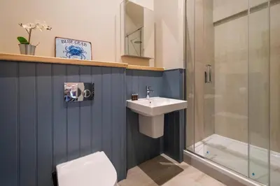 a bathroom with a toilet and a sink and a shower at Alde Bay Farm - Barn Owl Sanctuary in Aldeburgh