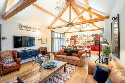 a living room with couches and a table at Alde Bay Farm - Barn Owl Sanctuary in Aldeburgh