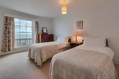 a bedroom with two beds and a window with a view at 3 Bed in Aldeburgh oc-marg in Aldeburgh