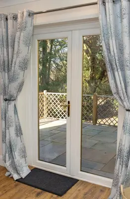 an open door with curtains in a room at The Lodge at Highlands in Everton
