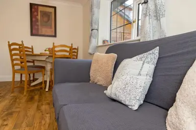 a blue couch in a living room with a table at The Lodge at Highlands in Everton