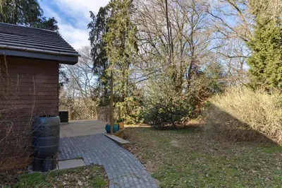 a backyard with a brick walkway next to a house at The Lodge at Highlands in Everton