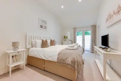 a bedroom with a bed with a desk and a television at 3 Bed in Snape oc-1wadd in Snape