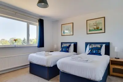 two beds in a room with a window at 3 Bed in Aldeburgh oc-10nw in Aldeburgh