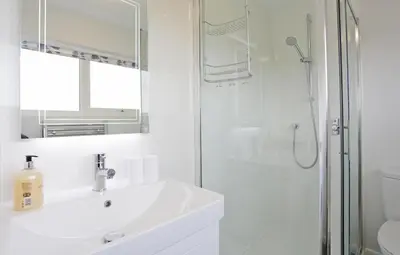 a white bathroom with a sink and a shower at 3 Bed in Aldeburgh oc-10nw in Aldeburgh