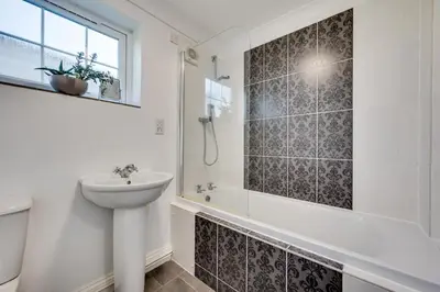 a bathroom with a sink and a shower and a toilet at 3 Bed in Belchamp Otten oc-2mf in Belchamp Otten
