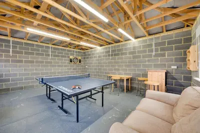 a ping pong table in a room with a brick wall at 3 Bed in Belchamp Otten oc-2mf in Belchamp Otten