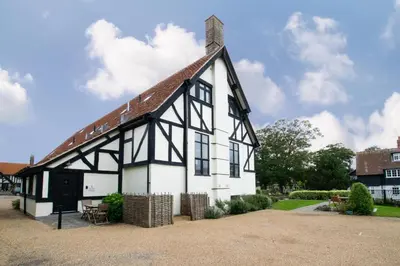 an old white and black building with a roof at 4 Bed in Thorpeness oc-barrh in Thorpeness
