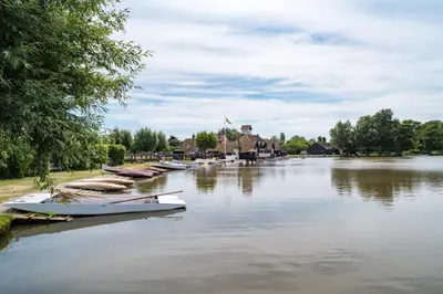 a group of boats are docked on a river at 4 Bed in Thorpeness oc-barrh in Thorpeness