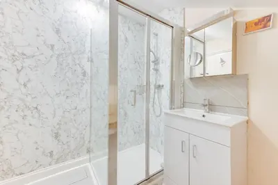 a white bathroom with a shower and a sink at 3 Bed in Aldeburgh oc-ahs in Aldeburgh