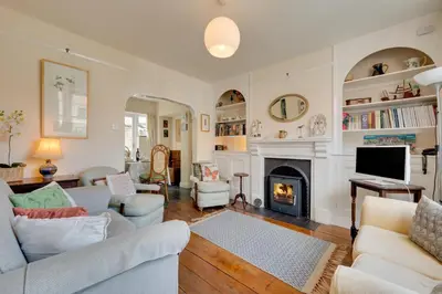 a living room with a couch and a fireplace at 3 Bed in Aldeburgh oc-ahs in Aldeburgh