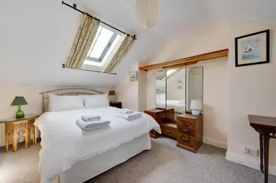 a bedroom with a large white bed and a mirror at 3 Bed in Aldeburgh oc-ahs in Aldeburgh