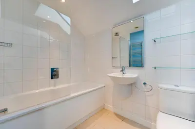 a bathroom with a sink and a tub and a toilet at 6 Bed in Knodishall oc-bil in Aldringham