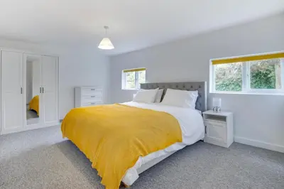 a white bedroom with a large bed with a yellow blanket at 4 Bed in Eastbridge oc-bricot in Theberton