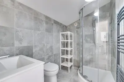 a bathroom with a toilet sink and a shower at 4 Bed in Eastbridge oc-bricot in Theberton